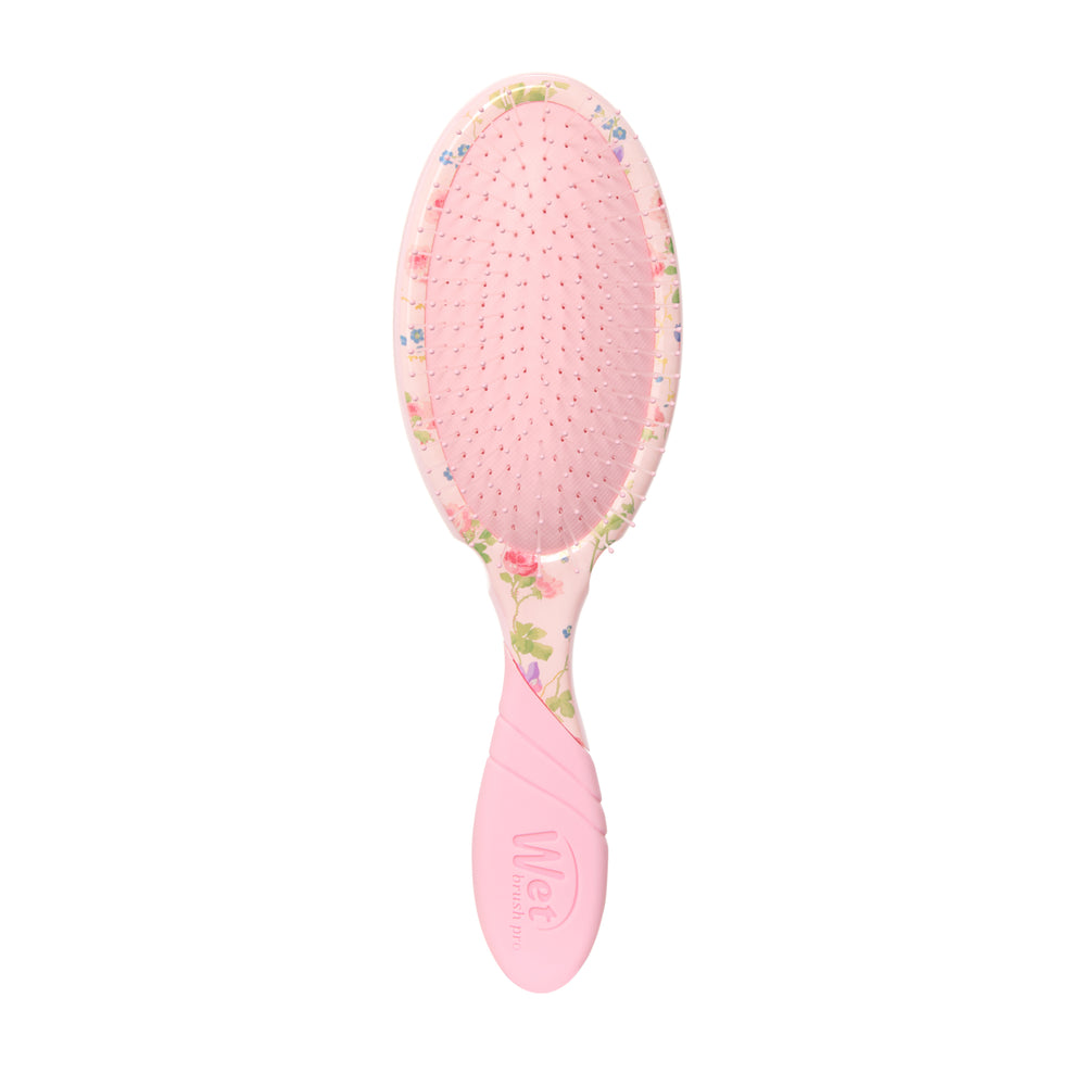 Pink hairbrush with floral pattern on a white background